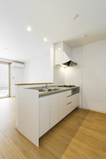 名古屋市北区のメゾネット賃貸アパートの白色のシンプルなオープンキッチン