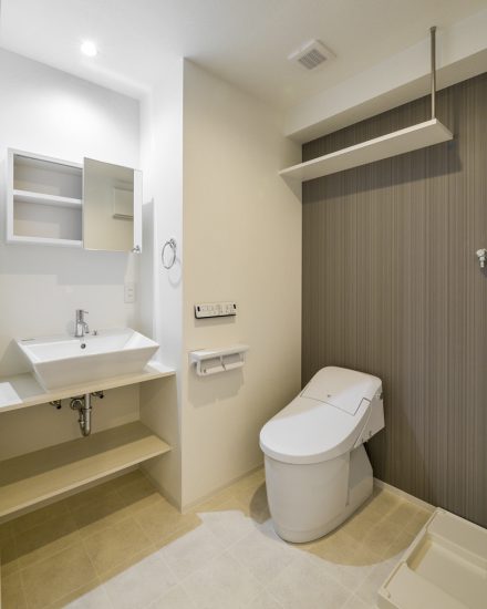 名古屋市昭和区の4階建て賃貸マンションのおしゃれな収納棚のついた洗面台とタンクレストイレ
