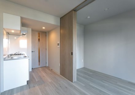 名古屋市千種区の13階建て賃貸マンションのコンパクトなキッチンと洋室