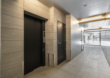 愛知県名古屋市千種区のモダンな賃貸マンションの大判タイルの高級感あるエレベーターホール